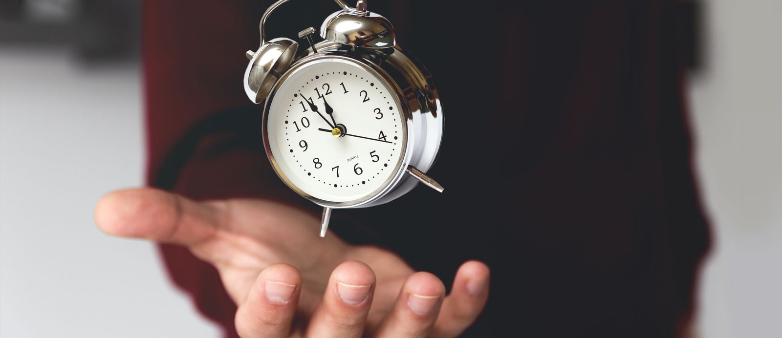 Manos de un hombre mostrando un reloj, una metáfora sobre la duración de los derechos de autor desde el momento de su creación.